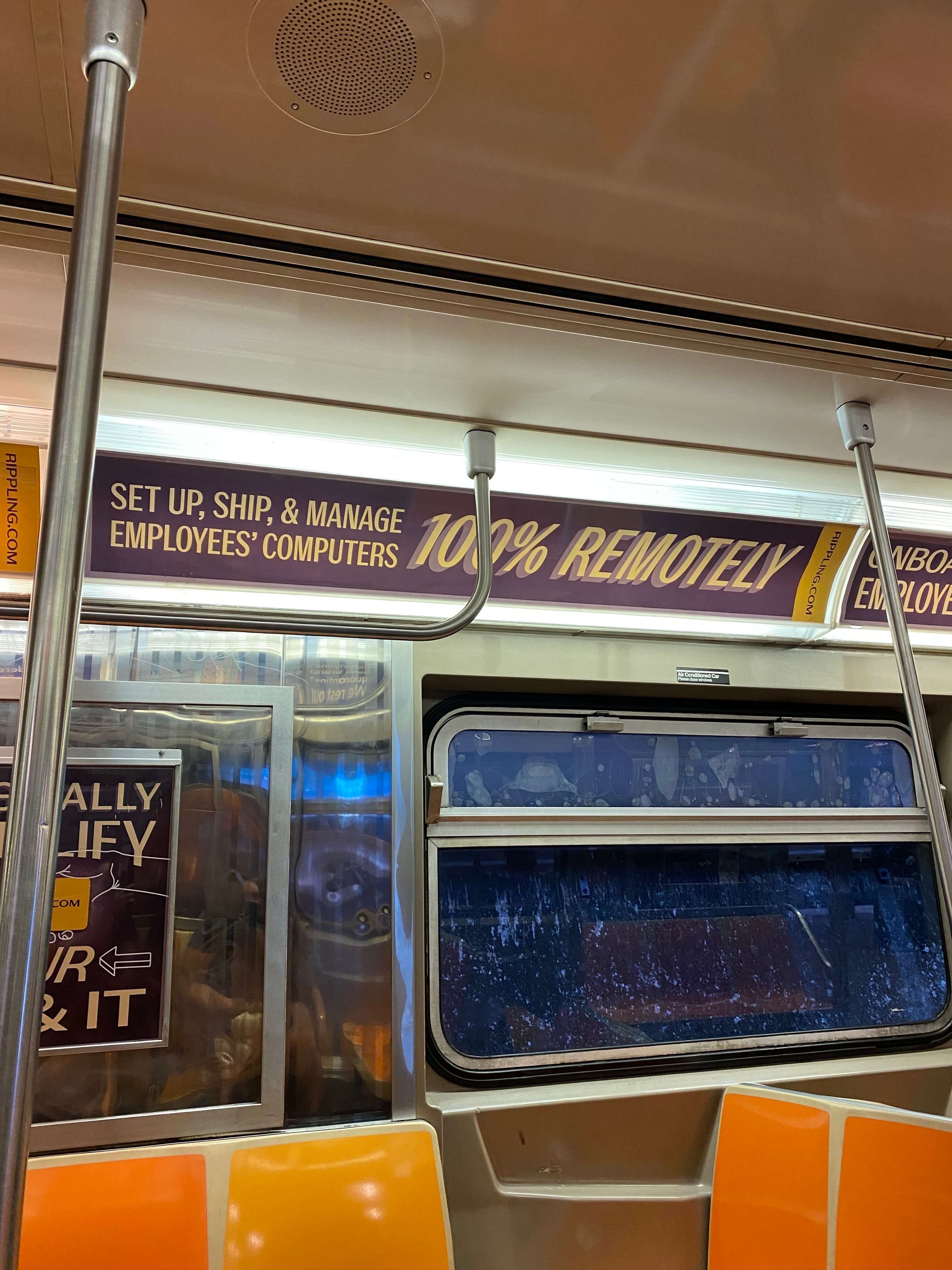 Rippling advertisement on the Subway that says, "Set up, ship & manage employee's computers 100% remotely."